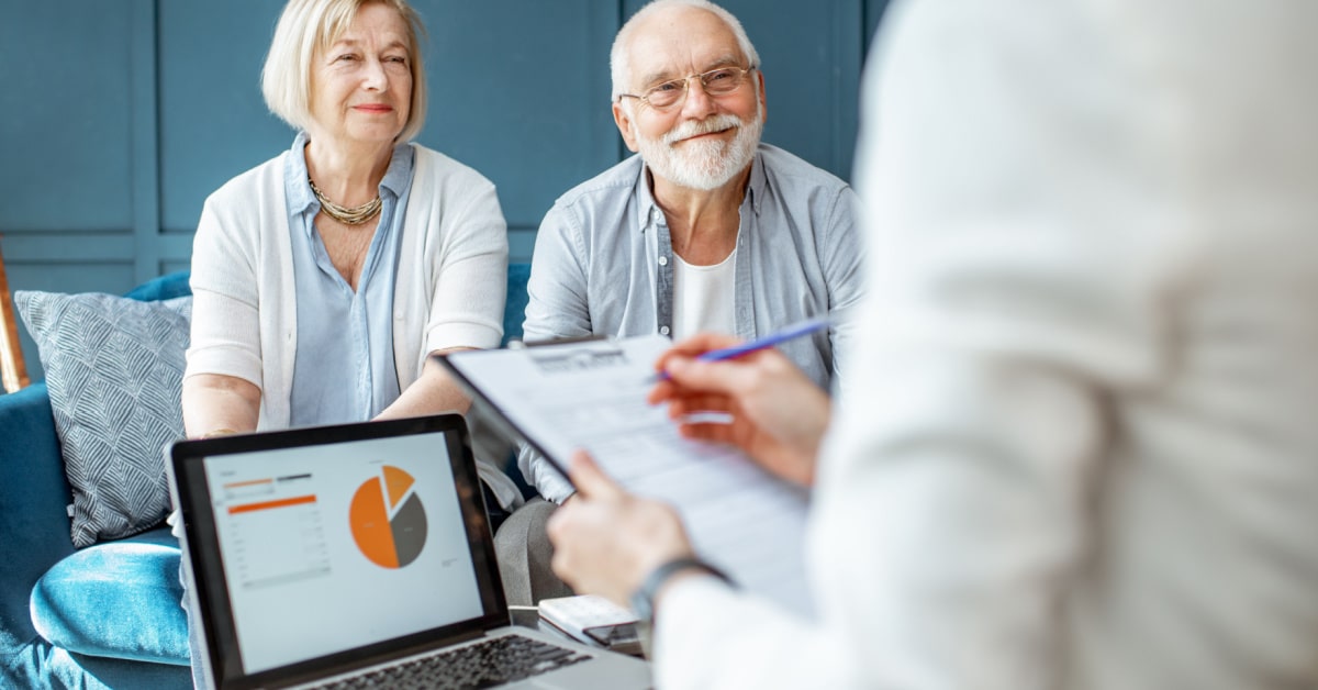 Wealth manager speaking with a couple elderly clients won through marketing automation.