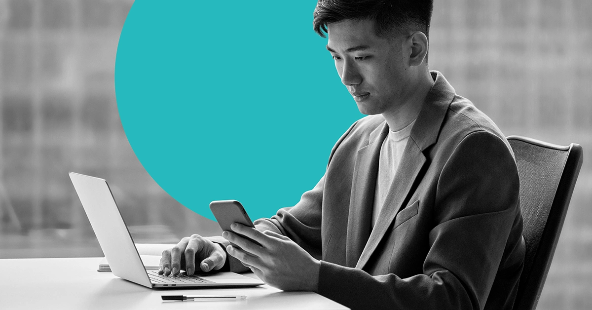 Marketer conducting A/B testing on a laptop and mobile device.