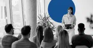 Woman addressing SEO frequently asked questions in front of a small group of people.
